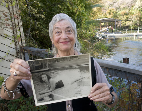 Aquarena Springs Peggy Sparks holds a photo of herself taken when she worked at Aquarena. Image by Andy Sharp for the American Statesman..