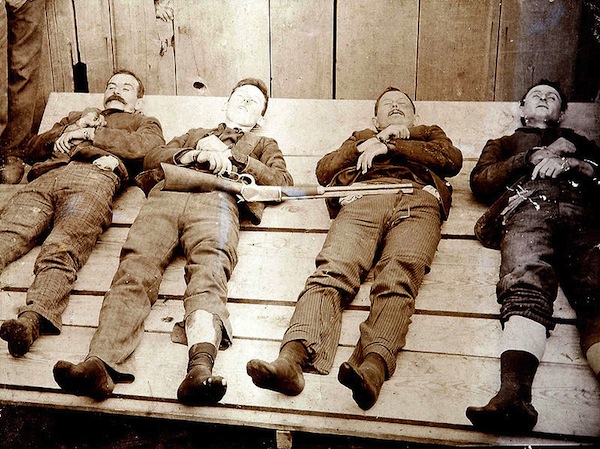 800px-Dalton_Gang_memento_mori_1892 A post-death photo, known as a memento mori, of the Dalton Gang, (from left) Bill Power, Bob Dalton, Grat Dalton, and Dick Broadwell. (From Cramers Art Rooms of Cherryvale, Kansas, via WikiCommons)