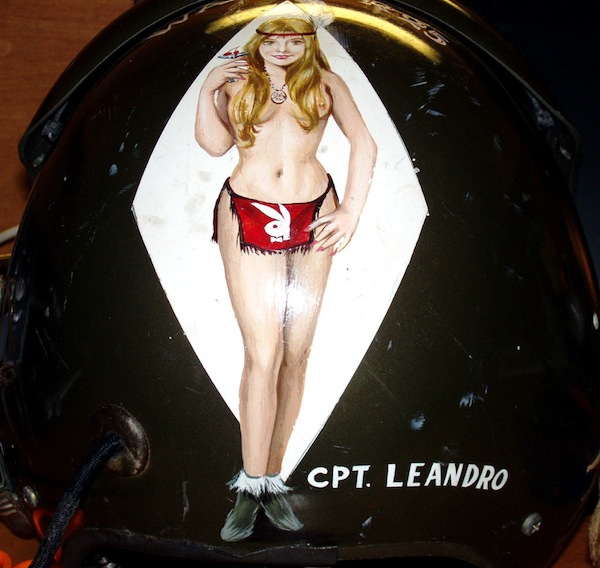 Helmet 002 Pin-up imagery was rare on Vietnam helicopter helmets, but this "enhanced" image of a crew chief's wife was also painted on the assault helicopter itself. (Courtesy of John Leandro, via VHPAMuseum.org)