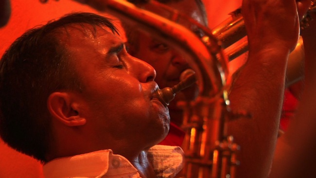 demiran-orange Demiran Ćerimović competes for the title for top trumpeter at the Guča Trumpet Festival in 2010. (Still from "Brasslands" courtesy of the Meerkat Media Collective)