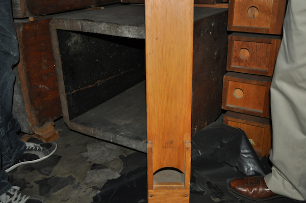 A number of wooden pipes, from the large gray one on the floor to smaller examples. Most are made of sugar pine.