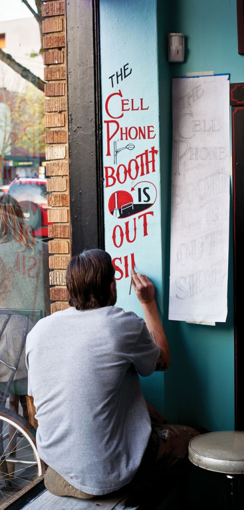 Sean Barton paints a tongue-in-cheek sign in Seattle, Washington. Courtesy Princeton Architectural Press.