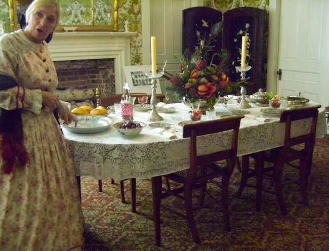 hallhousetable A tour guide in period garb shows the table at Hall House in Salisbury, North Carolina, built in 1820. The family of Dr. Josephus Hall, chief surgeon at the Salisbury Confederate Prison during the Civil War, owned two slave couples and their children. (Photo by Arnold Modlin)