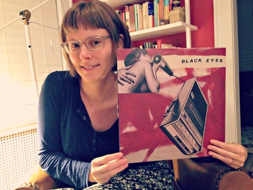 Top: O'Holla with Biff Bam Pow's "The Acid House Album." Above: O'Holla's latest review is for the self-titled Black Eyes album from 2002.