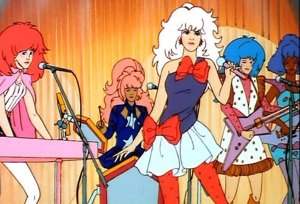 jem_cartoon Jem and Holograms play a song in their namesake animated series. From left, Kimber on keyboards, Raya on drums, Jem on vocals, Aja on guitar, and Shana on bass. (Via Jem.wikia.com)