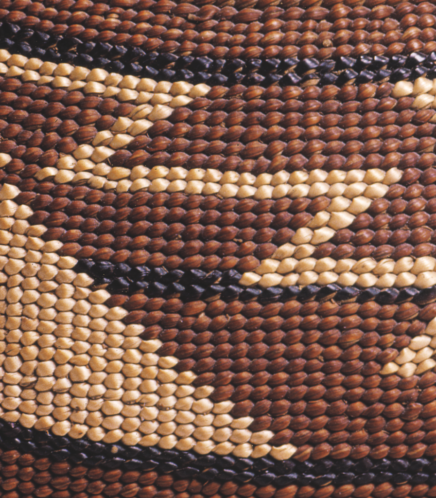 44 Twined Hat Detail of twining shows the deep red-brown color of dyed Woodwardia, white beargrass, and black maidenhair fern stem.