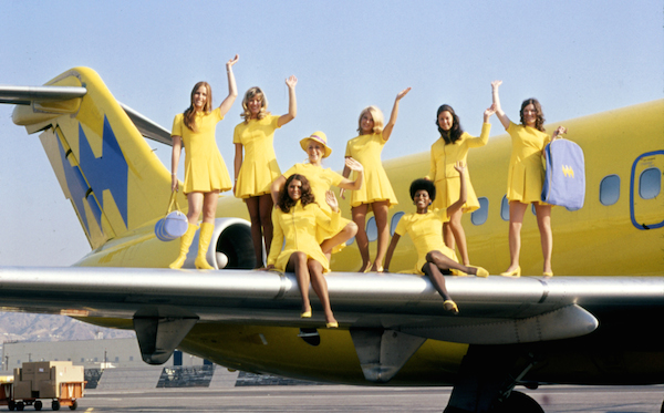 airlines_Hughes_1971_MuseumofflightEDIT Hughes Airways flight attendants pose on a plane's wing in 1971. (Via Museum of Flight)