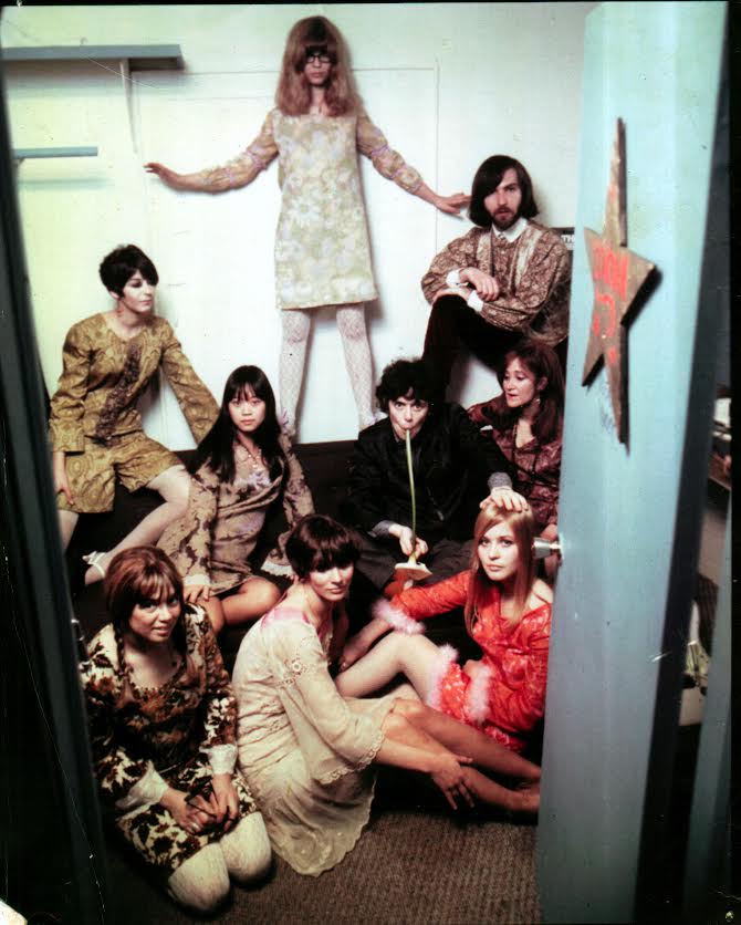 trina_60s_clothing_rockstars Trina Robbins (top) in Donovan's dressing room at The Trip, a club on the Sunset Strip in L.A., circa 1966. Everyone but Donovan (in the middle, sucking on a lily) is wearing clothes designed by Robbins. (Photo courtesy of Trina Robbins)