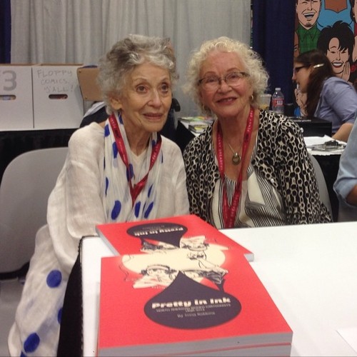 trina_current_comiccon_lilyrenee Golden Era comics artist Lily Renée, left, and Trina Robbins sign "Pretty In Pink" at the 2014 San Diego Comic-Con. (Via The Cartoon Art Museum Tumblr)