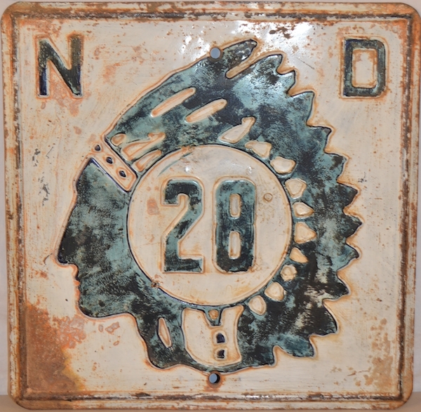 Mantique-edit_North Dakota Route 28 sign A North Dakota Route 28 highway sign features a silhouette based on a Lakota police officer named Marcellus Red Tomahawk. (Via "Mantiques")