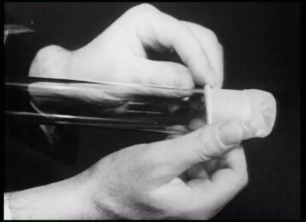 A WWII training film demonstrates how to put on a condom. (Still from “Sex(Ed): The Movie”)