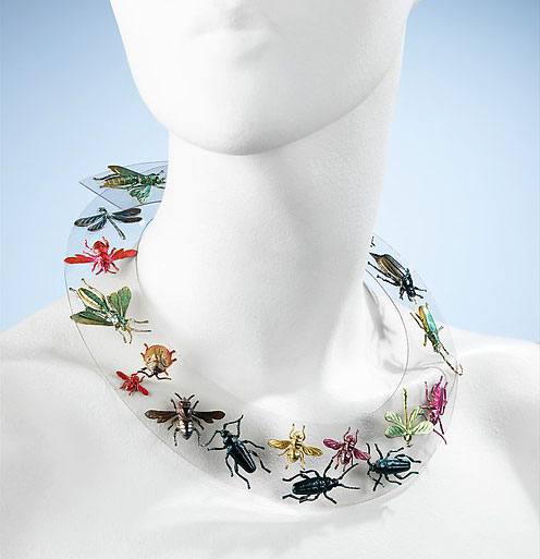 Top, Schiaparelli posed for Irving Berlin in this photograph taken for "Vogue" in 1948. ©1984 Irving Penn, courtesy of "Vogue." Above, a Schiaparelli necklace of metal insects mounted on clear plastic from 1938. <a href="http://www.metmuseum.org/collection/the-collection-online/search/155927?rpp=30&pg=6&ft=elsa%2Bschiaparelli&pos=166&imgNo=0&tabName=label">Courtesy the Metropolitan Museum of Art</a>.