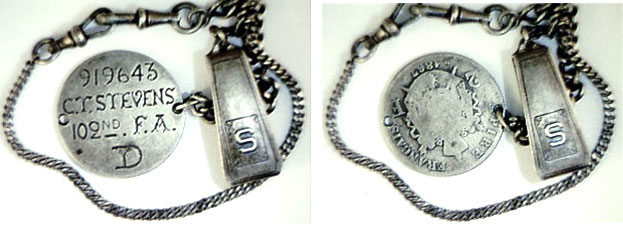 This watch chain is attached to a love-token dog tag on an 1867 French 2 Franc. It reads, "919643, C.T. Stevens, 102nd F.A., D," and F.A. stands for "Field Artillery." (Courtesy of the Love Token Society)