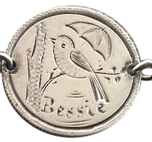 This Liberty seated dime, part of a man's watch chain, is engraved with a bird and an umbrella and the name, "Bessie," who might have been one of the man's daughters. (Courtesy of the Love Token Society)