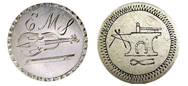 The love token with a violin and "EMS," left, was probably made for a musician, while the love token featuring an anvil and blacksmithing tools was probably made to represent a blacksmith. (Courtesy of the Love Token Society)