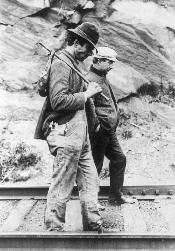 Two hoboes walk along railroad tracks, after being put off a train, circa 1907-1912. (Via Library of Congress)