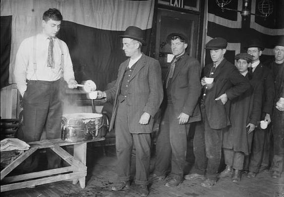 Hoboes line up for a breakfast of coffee at the New York City Hotel de Gink. (From the Bain News Service, Library of Congress)