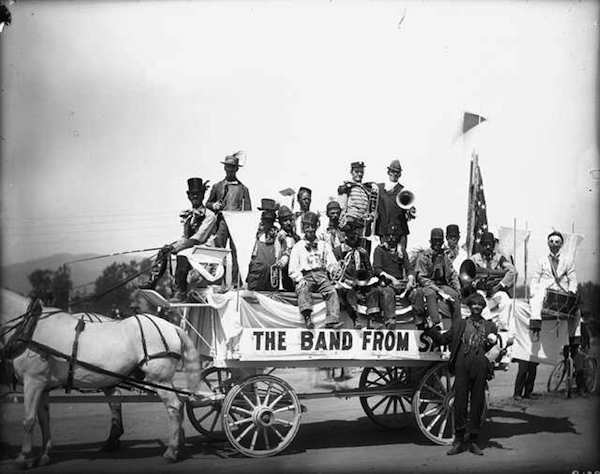 Band members wearing hobo costumes pose on a horse-drawn wagon. (From the Western History/Genealogy Department, Denver Public Library)