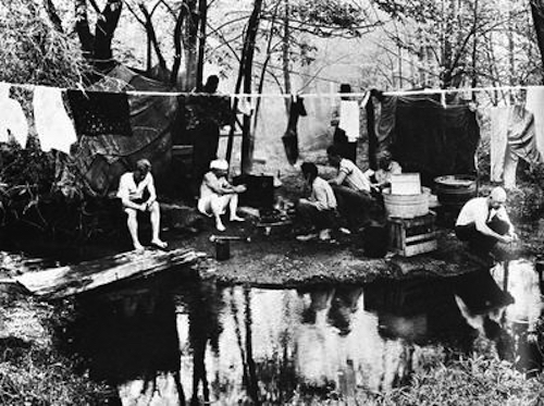 Hoboes at a jungle hang their washed laundry on a clothesline. (Via 1947project.blogspot.com)
