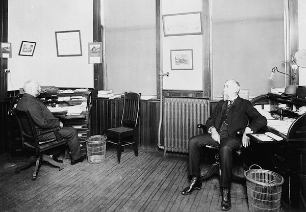 Henry Leland (right) and Robert Faulconer (left) of Leland & Faulconer, which became Cadillac, circa 1903, each with his own empty wicker waste basket. Photo via the <a href="http://www.loc.gov/item/det1994022729/PP/">Library of Congress</a>.