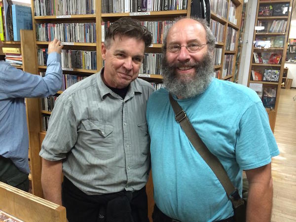 Don Campau and Al Margolis pose in front of a CD library in 2014. (Courtesy of Don Campau)