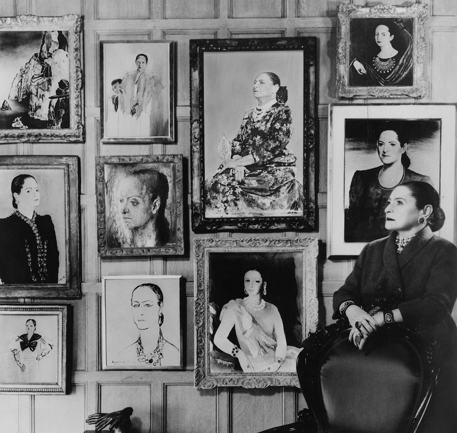 Helena Rubinstein in front of a montage of some of the many portraits she commissioned throughout her life. (From the Helena Rubinstein Foundation Archives, Fashion Institute of Technology, SUNY, Gladys Marcus Library, Special Collections)