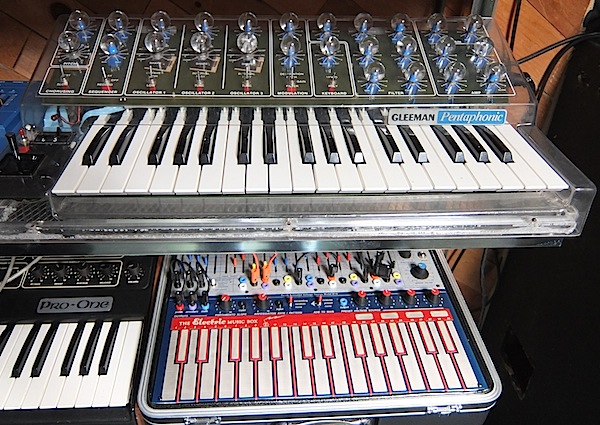 One of the gems of the Vintage Synthesizer Museum is a rare, clear, Gleeman Pentaphonic. Below that is a recent reissue of an Electric Music Box, often called a Music Easel, manufactured by Buchla. The Sequential Pro-One to the left is also fairly common.