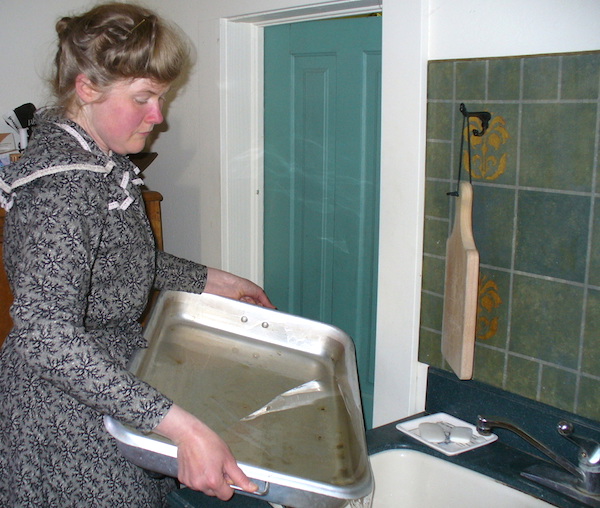Sarah empties the meltwater from her icebox’s drain pan twice a day. (From ThisVictorianLife.com)