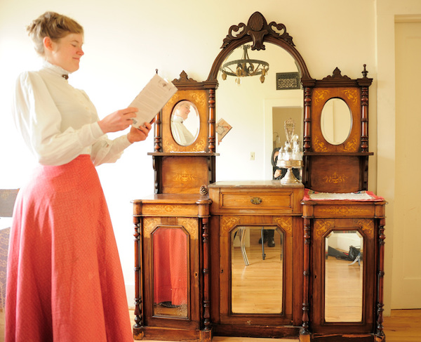 Sarah reads in her dining room, in front of her china hutch from 1860s Austria. (Photo courtesy Estar Hyo-Gyung Choi, Mary Studio, via ThisVictorianLife.com)