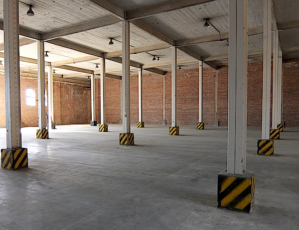 The inside of Building One features concrete floors and ceilings, with heavy steel framing throughout.