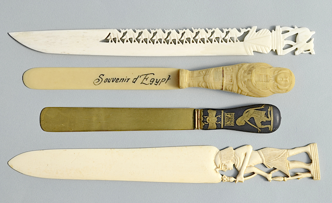 Souvenir paper-knives from Egypt made (from top to bottom) of bone, plastic, brass, and ivory.