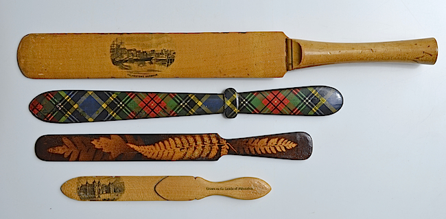 Mauchline ware paper-knives. From top: a cricket-bat design; tartan ware; fern ware; and a combination paper-knife and book marker.
