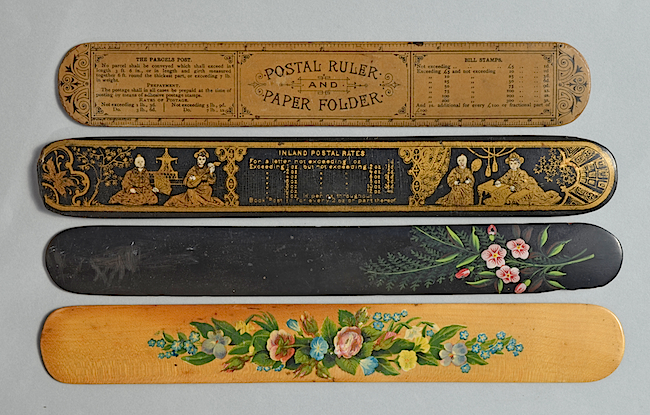 Paper folders or "creasers," as they were also known, were used to fold letters for envelopes, which is why they are often decorated with postal information. Unlike paper-knives and letter openers, paper folders were held along their top horizontal edges, so they needed to be wide but did not require handles.