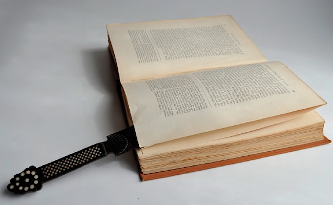 A paper-knife inserted between the uncut leaves of an 1882 book titled The History of Indian Literature. Each signature has 16 leaves requiring four cuts. The paper-knife is from Sri Lanka and is made from palm wood, with bone and horn decoration.