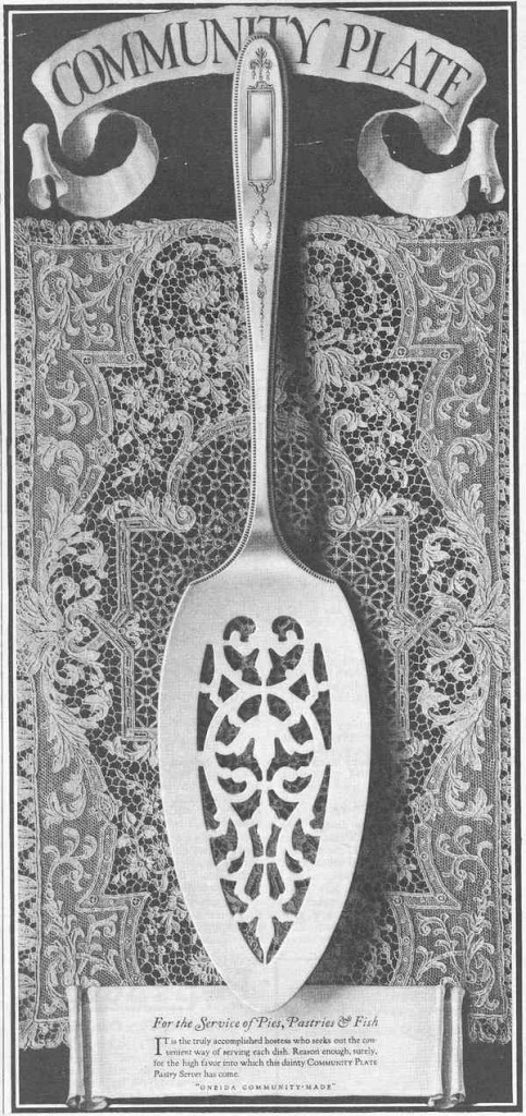 A Community Plate ad introducing a utensil "for the service of pies, pastries, and fish" in the "Grosvenor" pattern places the silverware on an intricate lace background. Click on the image to see it larger. (Via Nancy Eleanor Gluck's "Silver Threads" blog)