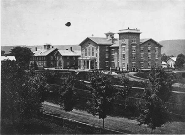 This photo from June 25, 1863, shows the newly completely Mansion House (right) next to the old (left). The expansion of the new Mansion House was completed by 1878. (Photo by O.A. Hollenbeck. From the Oneida Community Collection at Syracuse University Library in New York)