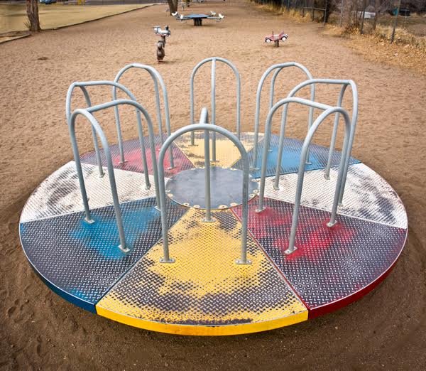 This merry-go-round, photographed in Cañon City, Colorado, in 2006, is very similar to the Lifetime Whirl above. In the background are a rideable jalopy and animals, including four attached to a teeter-totter. (Photo by Brenda Biondo)