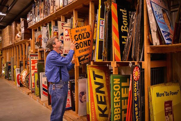 Cracker Barrel décor manager Larry Singleton peruses the sign collection in the company's 26,000-square-foot antiques warehouse. (Courtesy of Cracker Barrel Old Country Store)