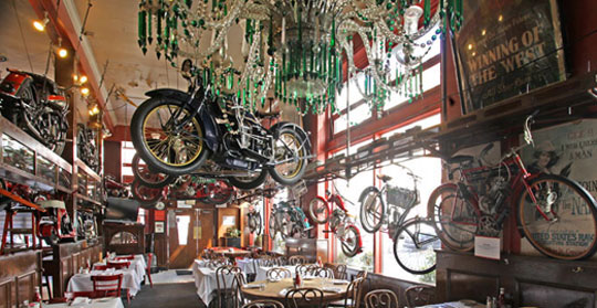 Henry Africa's collection of vintage motorcycles hung from the ceiling of Eddie Rickenbacker's in San Francisco until 2011. (Via Cyril Huze Post)