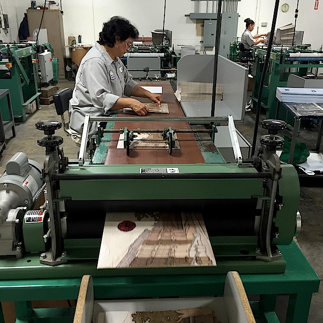 At Stoughton Printing Company, cover art is still mounted to jacket blanks by hand.