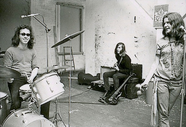 The poster behind Joplin's head is for a Steve Miller concert in September of 1967, which helps date this photo the the fall of 1967.