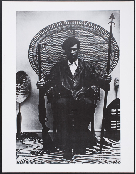 Eldridge Cleaver composed this famous 1966 image of Huey Newton, shot by Blair Stapp. Newton holds a spear and a gun while surrounded by Africana. (Courtesy of the Oakland Museum of California, All of Us or None Archive)