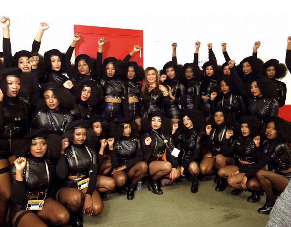 Top: From left, black activists T.C. Williams, Judy Hart, Ron Bridgeforth, and Jo Ann Mitchell at San Francisco State University in 1967. (Courtesy of Judy Juanita) Above: Beyoncé's dancers raise their fists in solidarity with the Black Panther Party backstage at Super Bowl 50 in February 2016. (Via Twitter)