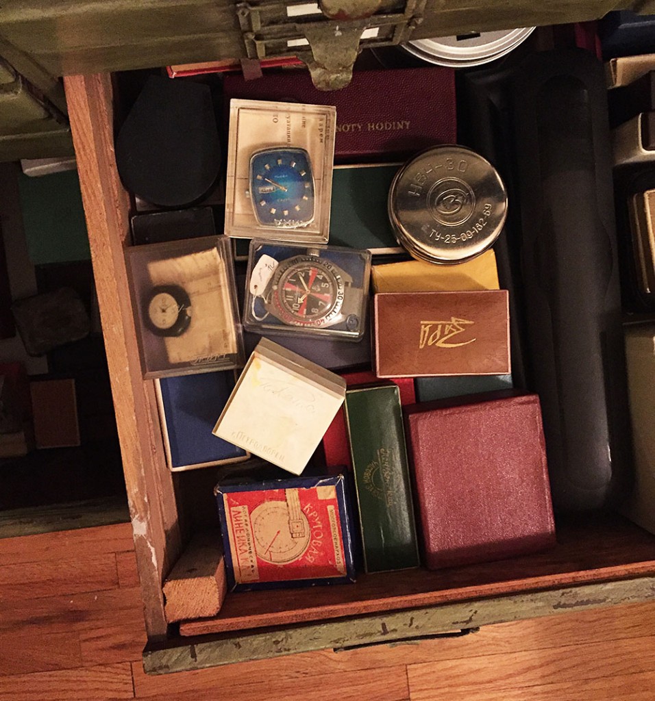 A drawer of new old stock (NOS) pieces in their original boxes, including the first Soviet quartz watch, the Chaika 3050, which has a blue rectangular face.