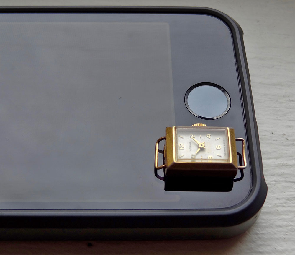 At just 12mm across, the Chaika 1200 is the smallest watch ever produced by the Soviet Union (seen here on an iPhone for comparison).