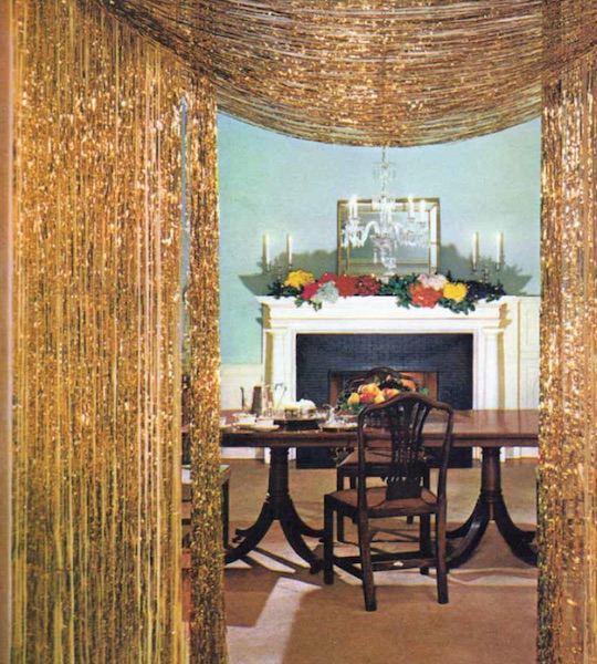 Top: A happy housewife can't believe the abundance of Christmas presents she sees in an 1960s ad for Reynolds Metals foil gift wraps. (From Mid-Century Christmas, reproduced with permission from Reynolds Consumer Products) Above: Gold tinsel curtains adorn the entry to a dining room in the December 1961 "House Beautiful." (From Mid-Century Christmas, reprinted with permission of Hearst Communications, Inc.)