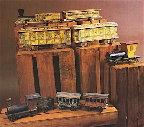 In the second half of the 19th century, wooden model trains such as the ones in the top two rows featured lithographed designs. Tin trains, at right and at bottom, were produced concurrently with wooden ones.