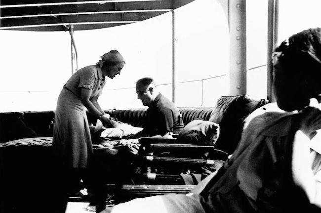 Roosevelt's chief of staff, Missy LeHand, conferring with the president aboard the Potomac in 1939.