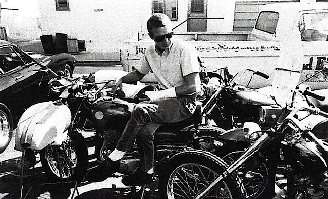 McQueen in his element in the parking lot of the Bud Ekins motorcycle dealership. The cast on his wrist puts this photo as circa 1964, just before he competed in the International Six Days Trial in what was then East Germany. Neile Adams McQueen collection, from McQueen's Motorcycles.