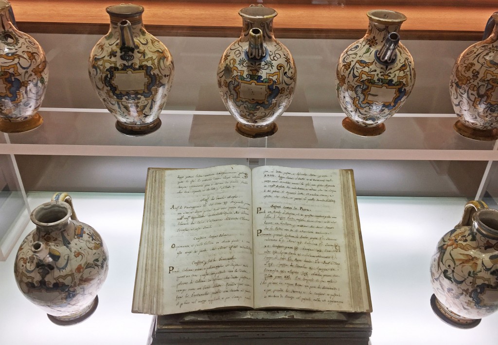 Original texts and ceramic vessels used by the friars are housed in the shop's museum. The heading on the righthand page reads "S<em>egreti Contro la Peste</em>” or “Secrets Against the Plague.”